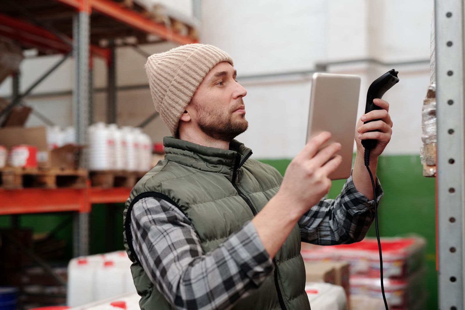 Field auditor scanning a warehouse shelf