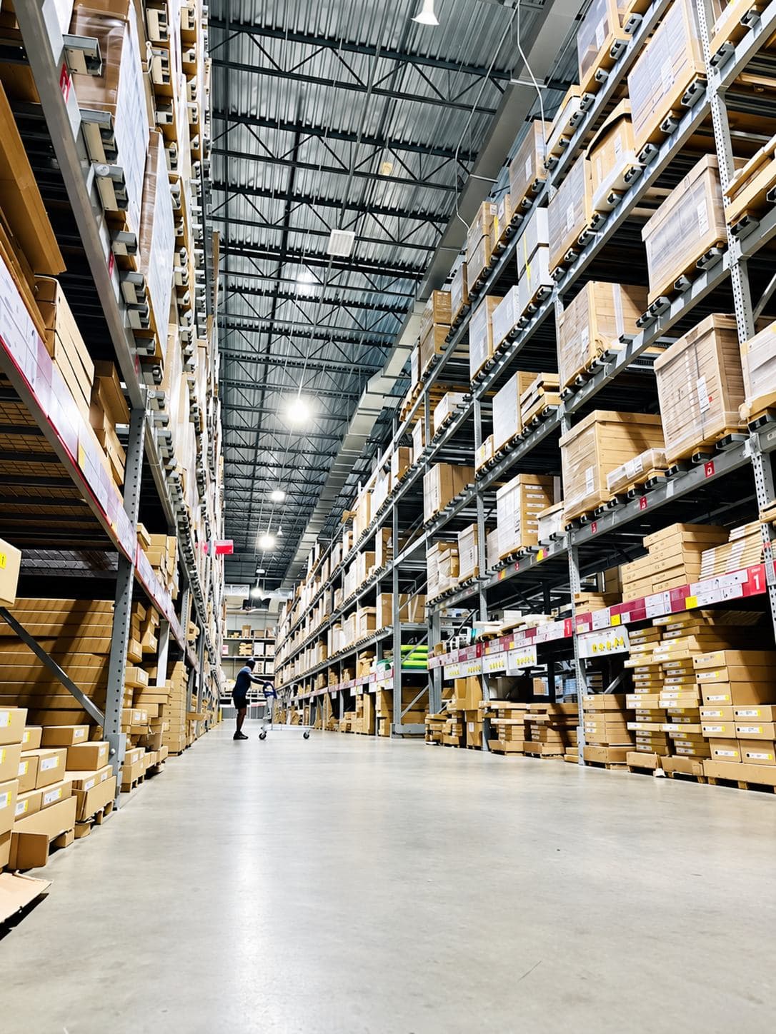 Tall warehouse aisle lined with organized inventory racks